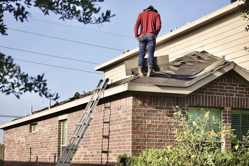 Professional roofer working on a residential roof in River Run
